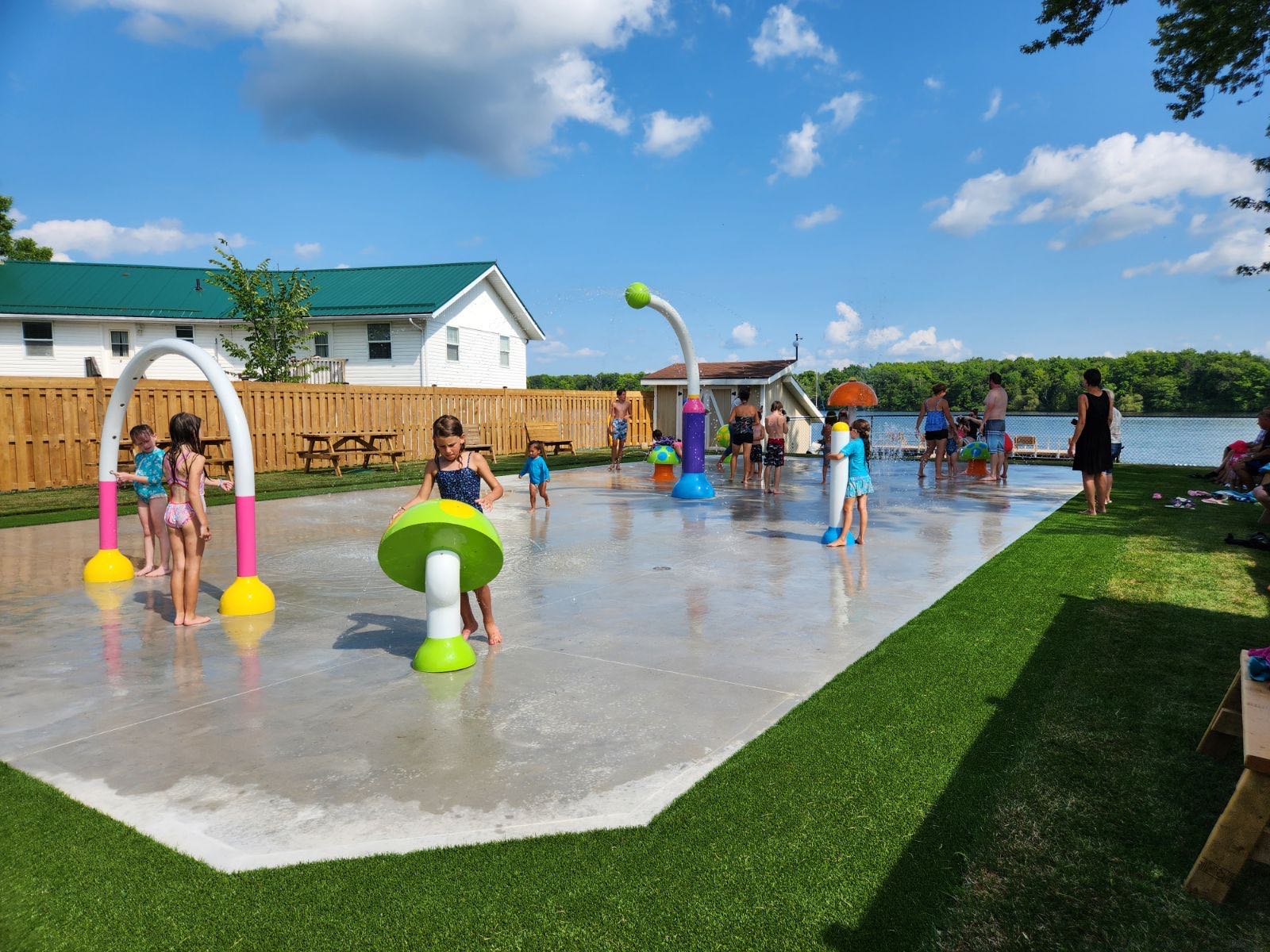 Children frolic and play in the newly opened splash pad at Elim Lodge